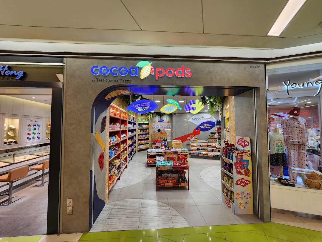 The vibrant entrance of Cocoa Pods by The Cocoa Trees, showcasing its inviting interior filled with treats.