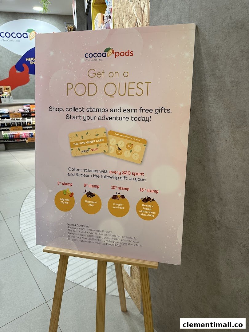 A promotional standee for Cocoa Pods' 'Pod Quest' loyalty program, detailing stamp collection and rewards.