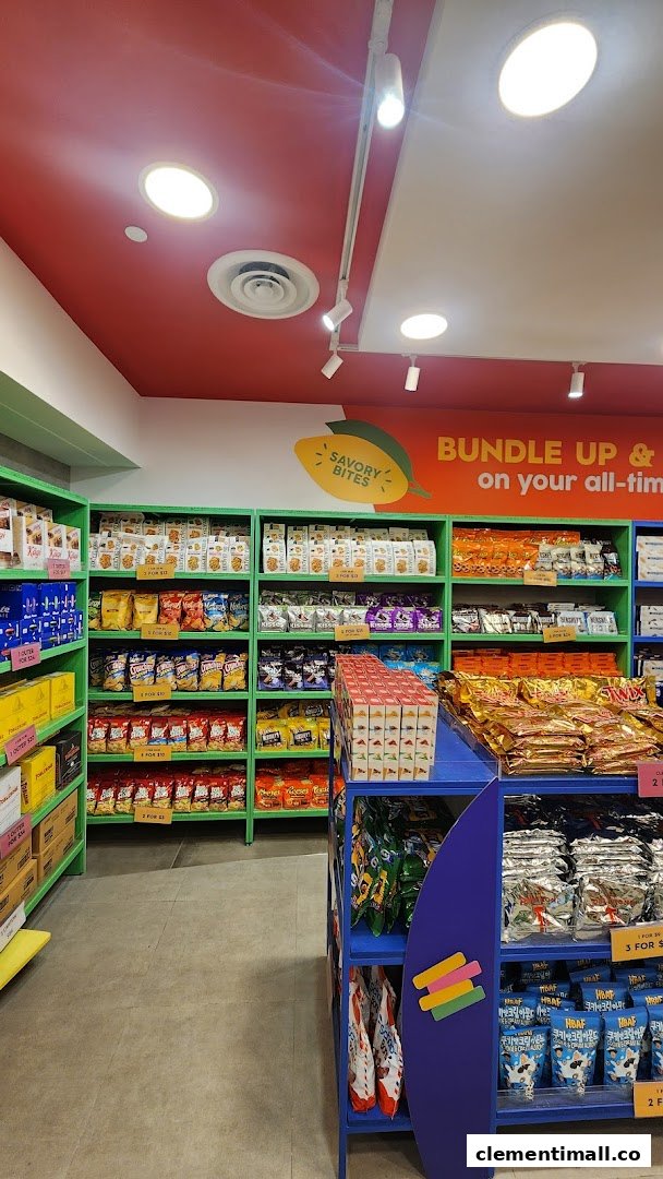 Interior view of Cocoa Pods by The Cocoa Trees, showcasing shelves filled with a variety of snacks and confectionery.