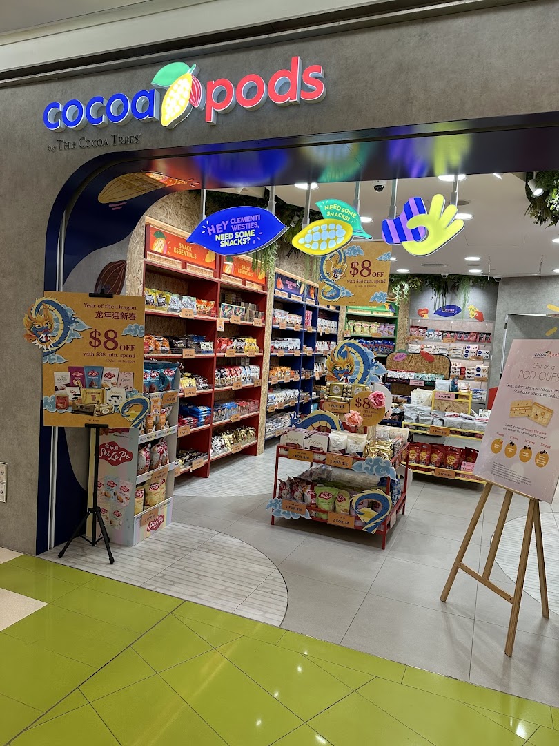 The Cocoa Pods shop entrance features colorful signage, inviting displays, and a wide array of snacks.