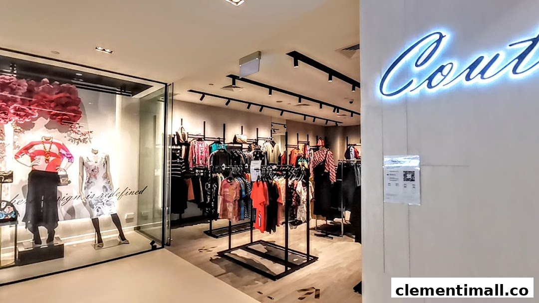 Interior view of Couture by Szan, showcasing mannequins in the window and racks of stylish clothing.
