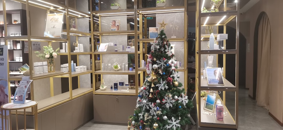 An interior view of Donna Beauty, showcasing skincare products on illuminated shelves and a festive Christmas tree.