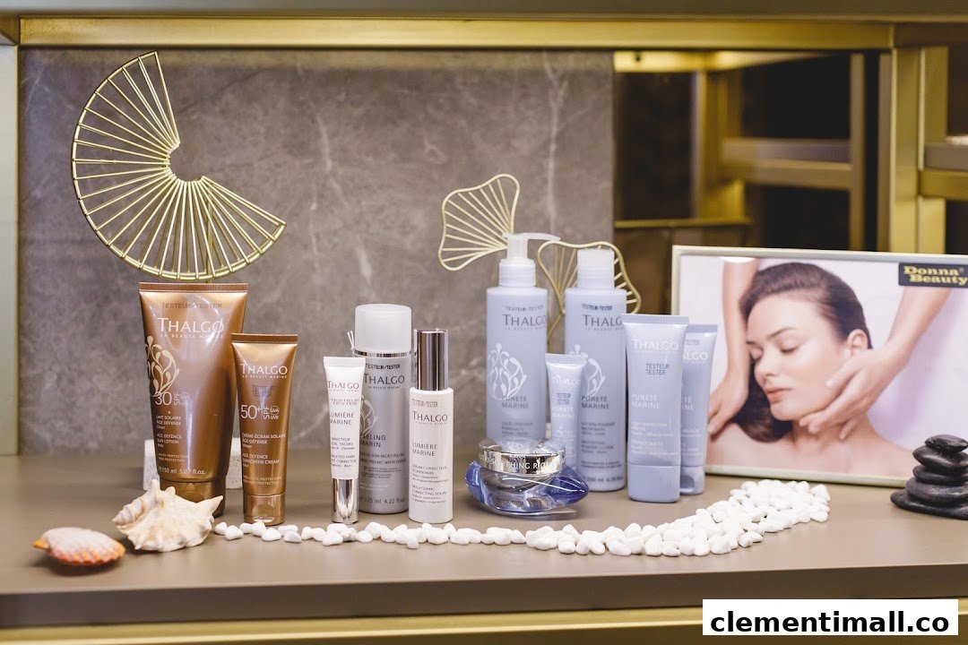 A display of Thalgo beauty products, including skincare and sun protection, with decorative elements like seashells and a framed image.