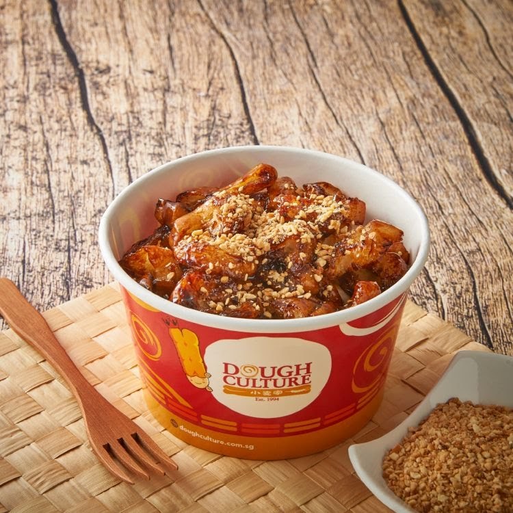 A delicious cup of Dough Culture's signature fried snack, topped with crunchy peanuts, ready to be enjoyed.