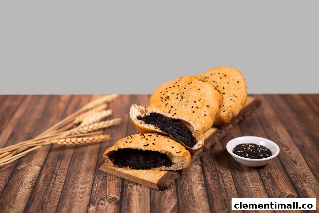 Golden pastries filled with black sesame paste, garnished with sesame seeds and wheat stalks.