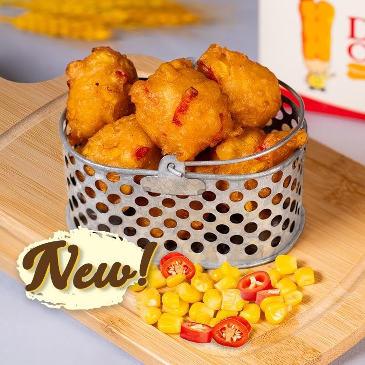 Golden fried dough balls served in a metal basket with corn and chili, highlighted as 'New!'.
