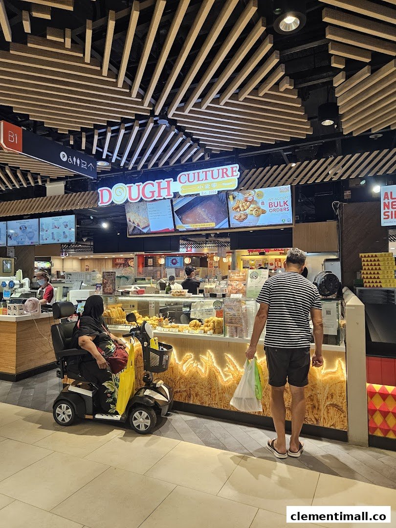 A bustling Dough Culture outlet with customers, showcasing a variety of fried dough products and a vibrant display.