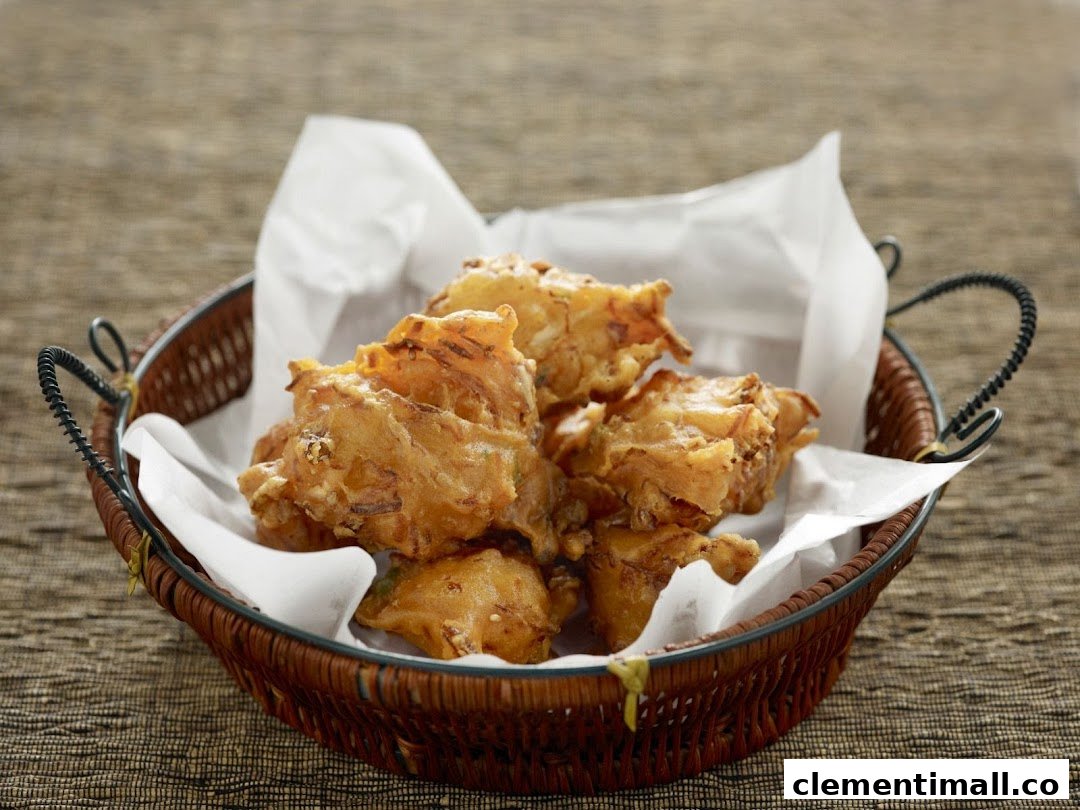 A basket of golden-brown fried dough fritters, served on white paper.