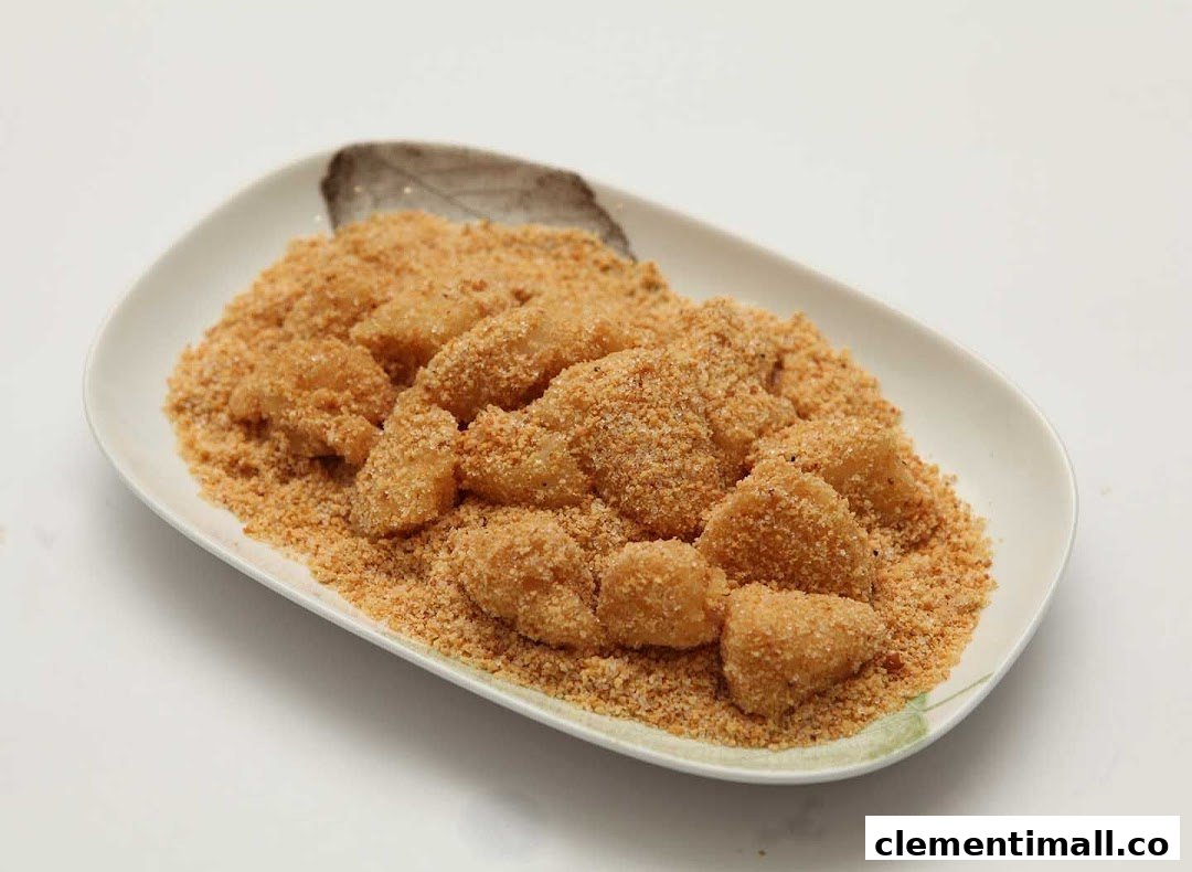 A plate of traditional glutinous rice cakes coated in finely ground peanut powder.
