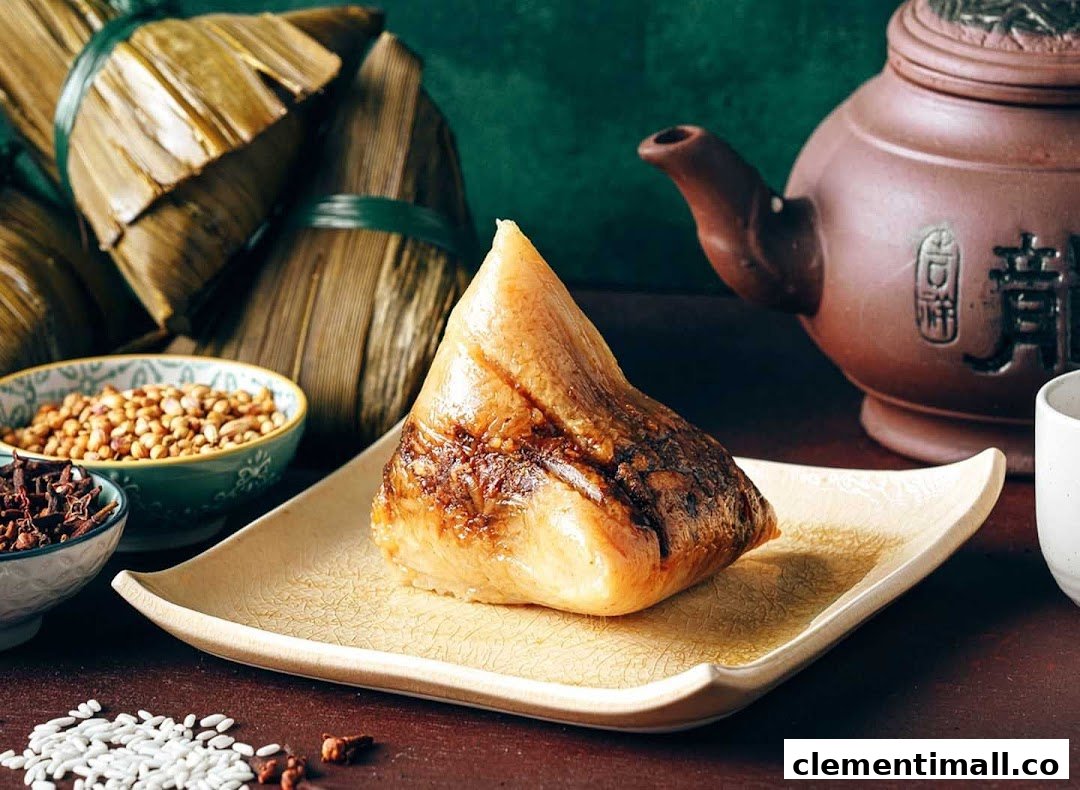 A delicious, unwrapped rice dumpling (zongzi) on a plate, with wrapped dumplings and tea in the background.