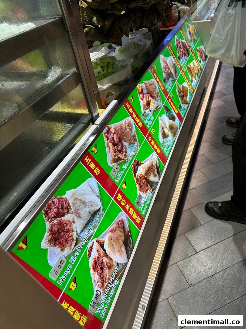 A brightly lit display showcasing various types of traditional rice dumplings with prices.