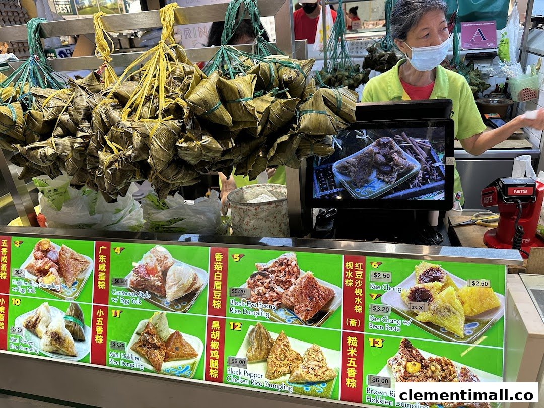 A vendor at Eastern Rice Dumpling stall with various rice dumplings and a detailed menu.