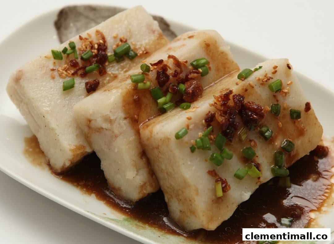 Three pieces of steamed radish cake with savory sauce and green onions on a white plate.