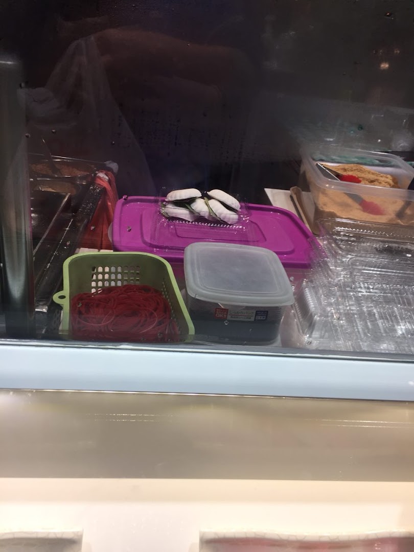 A display case showing various food items, including white dumplings or mochi, and other ingredients.