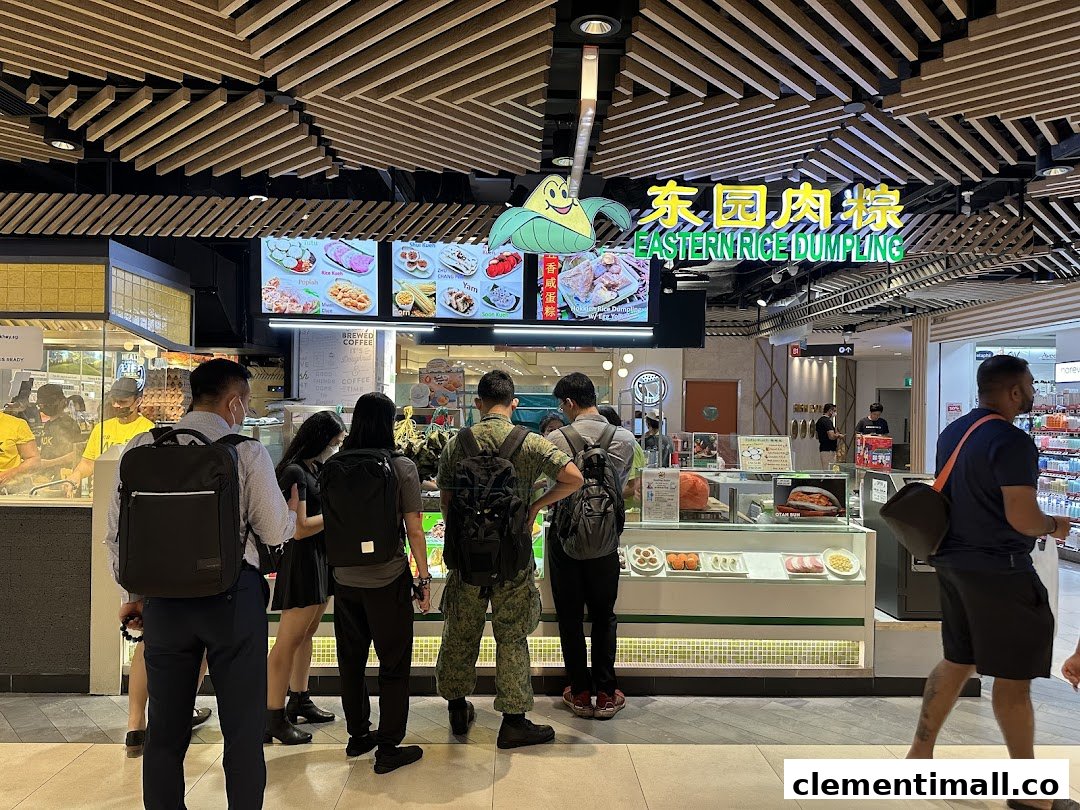 Customers queue at Eastern Rice Dumpling, featuring digital menus and food displays.