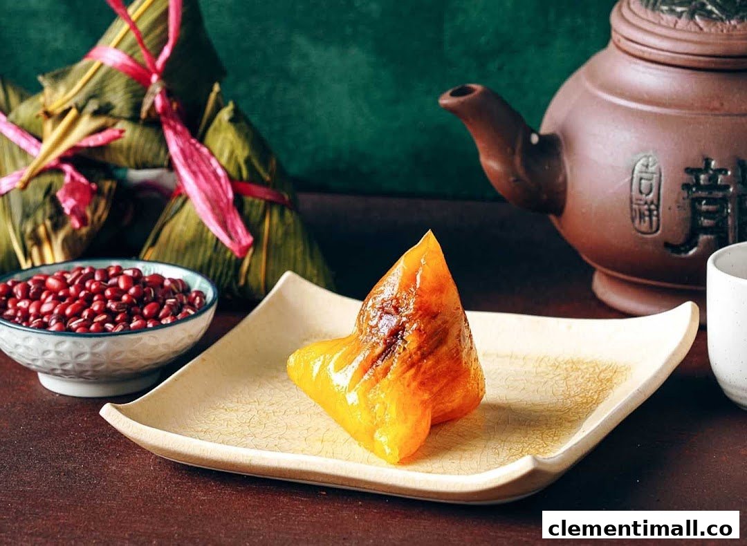A traditional rice dumpling on a plate, with red beans, wrapped dumplings, and a teapot.