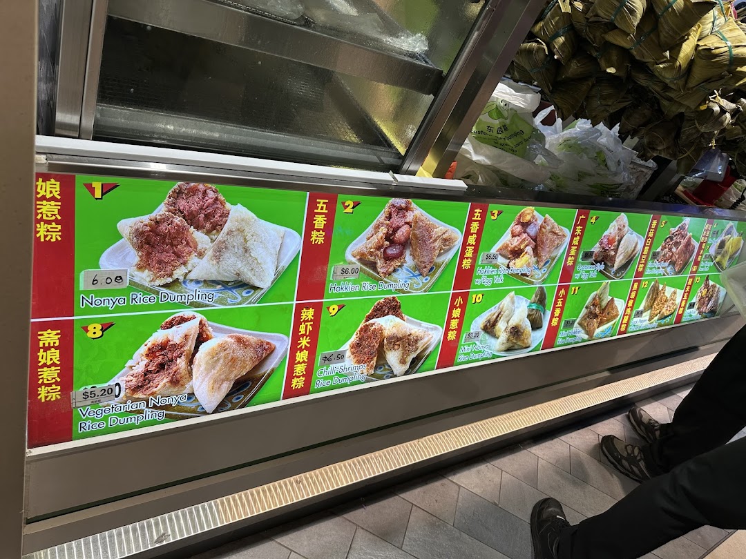 A vibrant display of various traditional rice dumplings with prices and descriptions at Eastern Rice Dumpling.