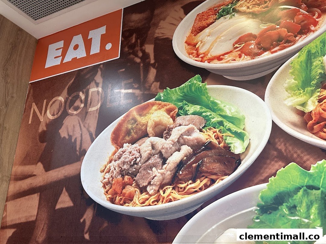 A vibrant wall display showcasing various delicious noodle dishes from the 'EAT.' shop.