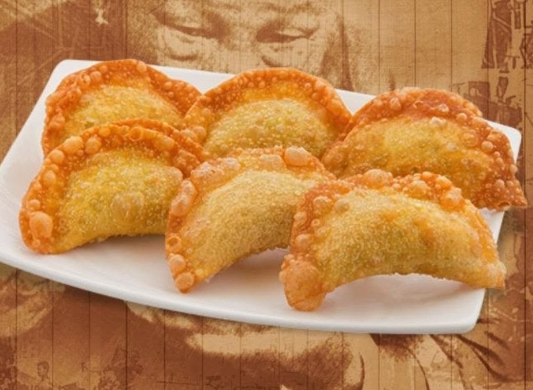 A plate of golden-brown, crispy fried dumplings or wontons, ready to be enjoyed.
