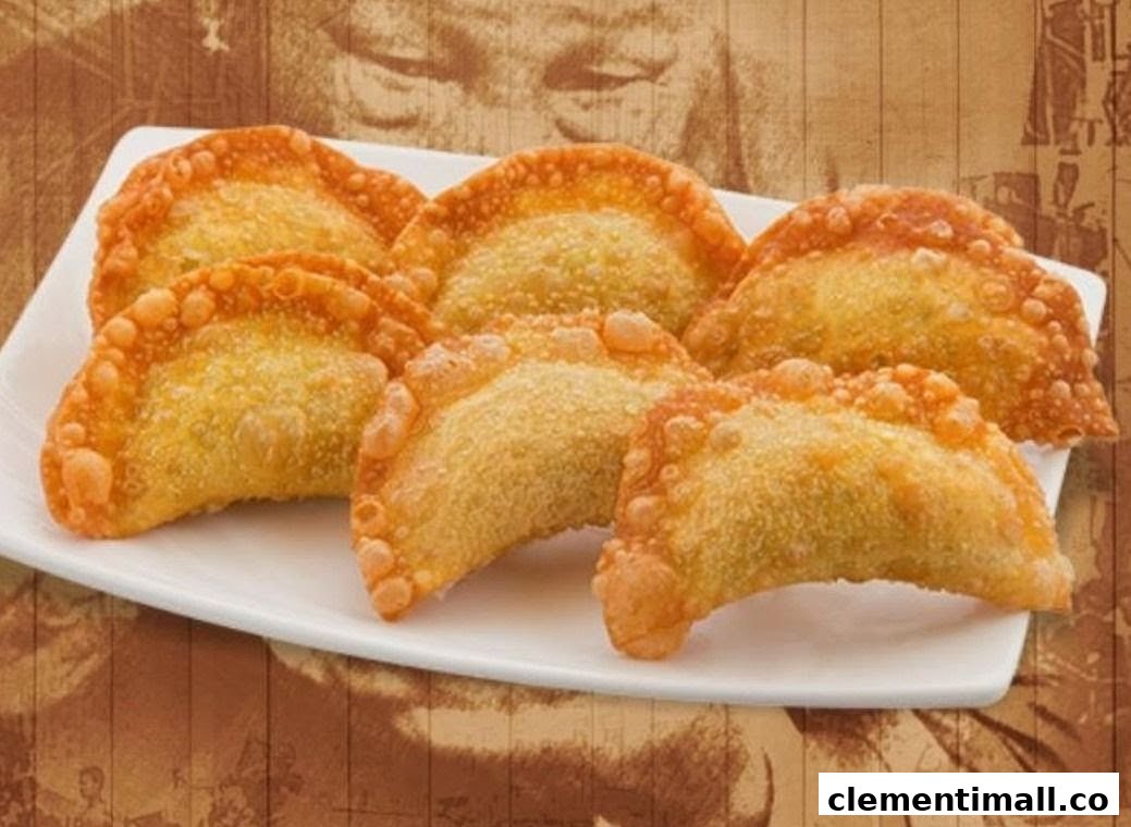 A plate of golden-brown, crispy fried dumplings or wontons, ready to be enjoyed.