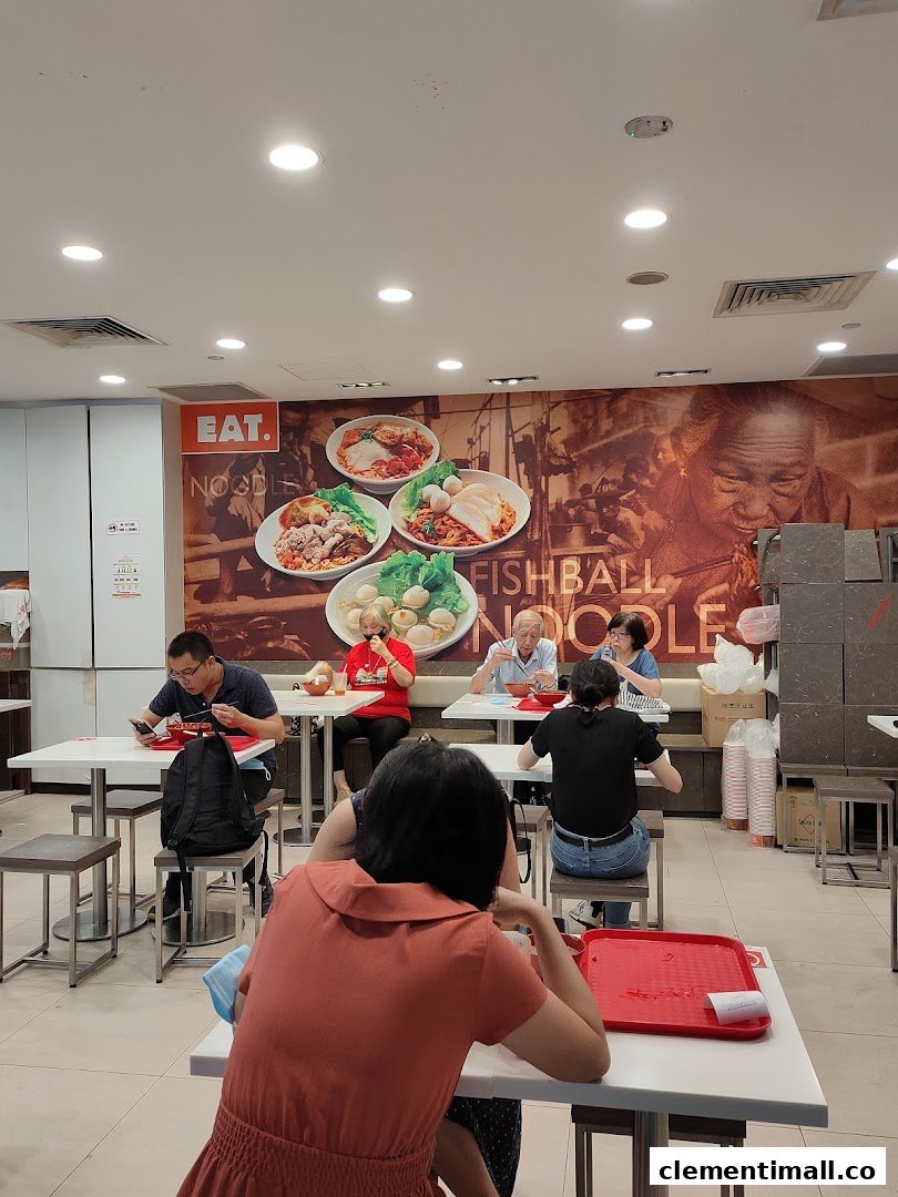 Customers enjoy meals at EAT., a casual eatery with a large wall mural featuring noodle dishes.