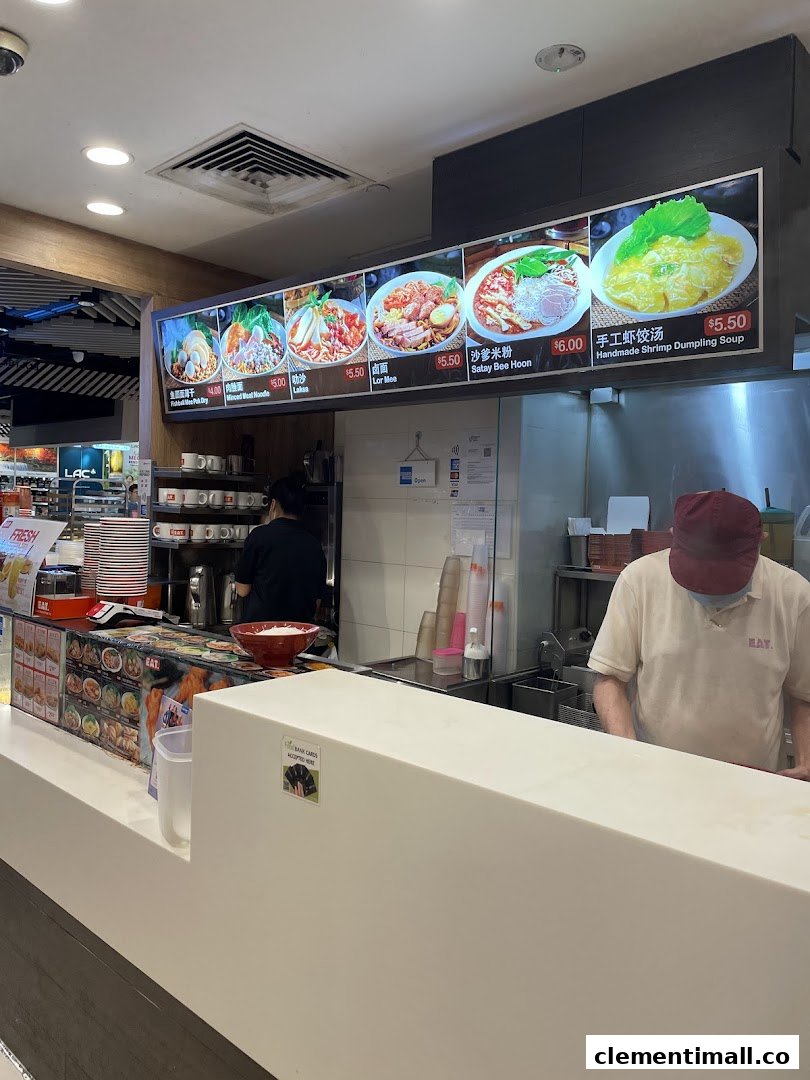 A food stall at EAT. featuring a digital menu board with various noodle and dumpling dishes.