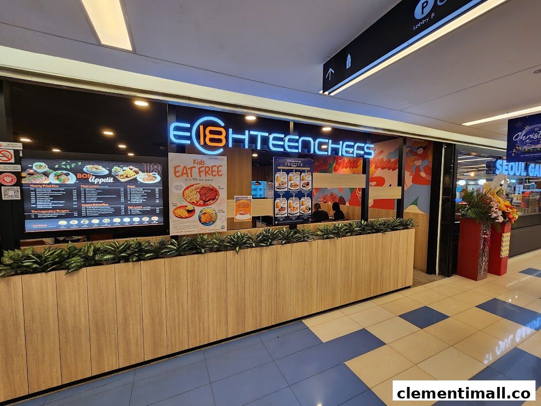 The brightly lit entrance of Eighteen Chefs restaurant with a digital menu board and promotional posters.