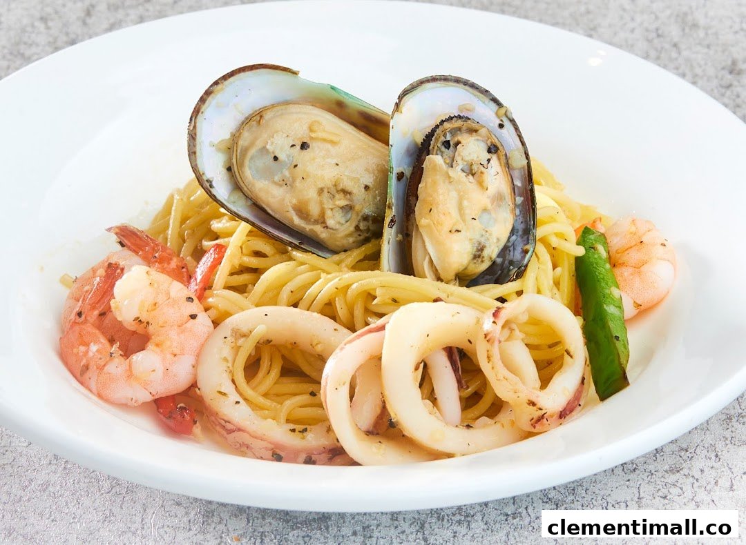 A close-up of a seafood pasta dish with mussels, prawns, and squid.