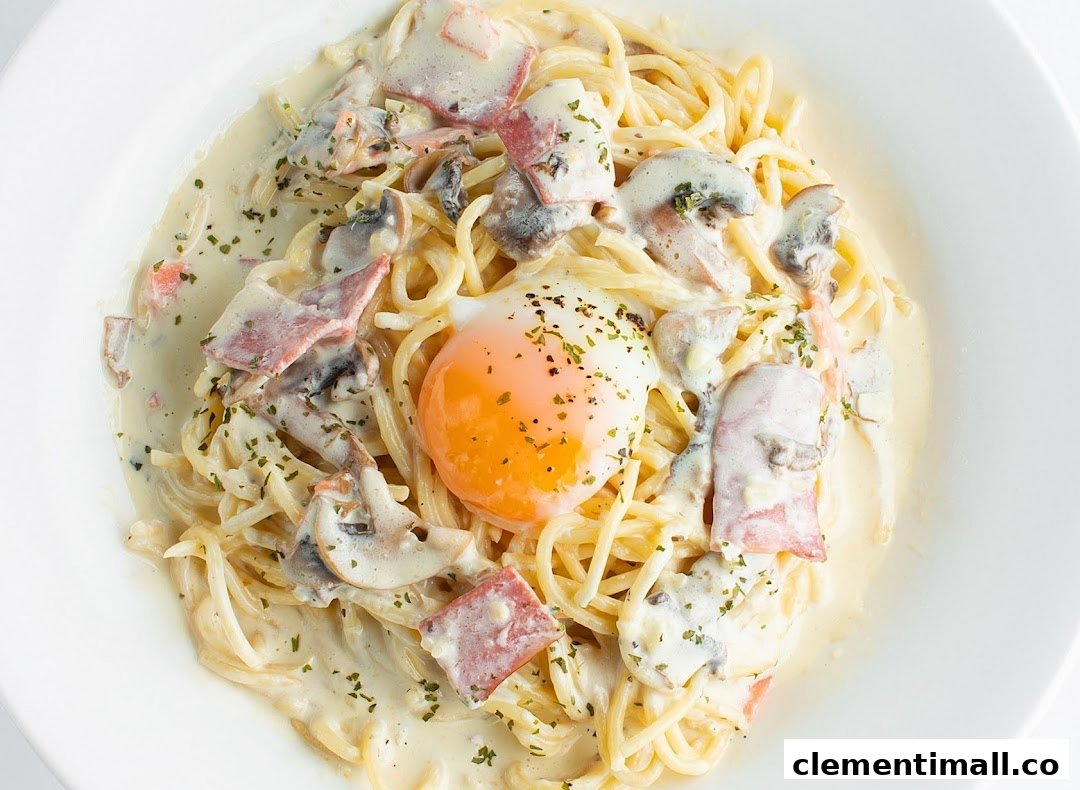 A creamy spaghetti carbonara dish with bacon, mushrooms, and a perfectly poached egg.