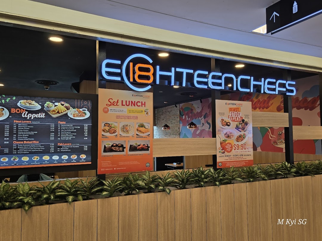 The shop front of Eighteen Chefs Clementi Mall, featuring its neon sign and promotional posters for set lunches and student meals.
