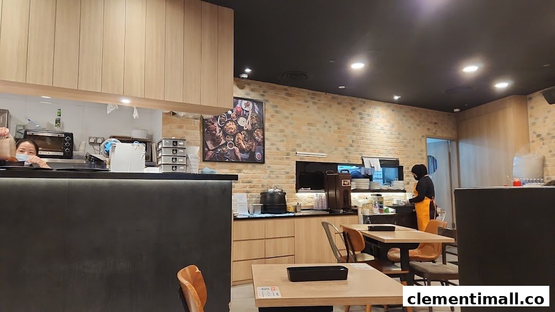 Interior view of Eighteen Chefs restaurant showing staff, kitchen counter, and dining area.
