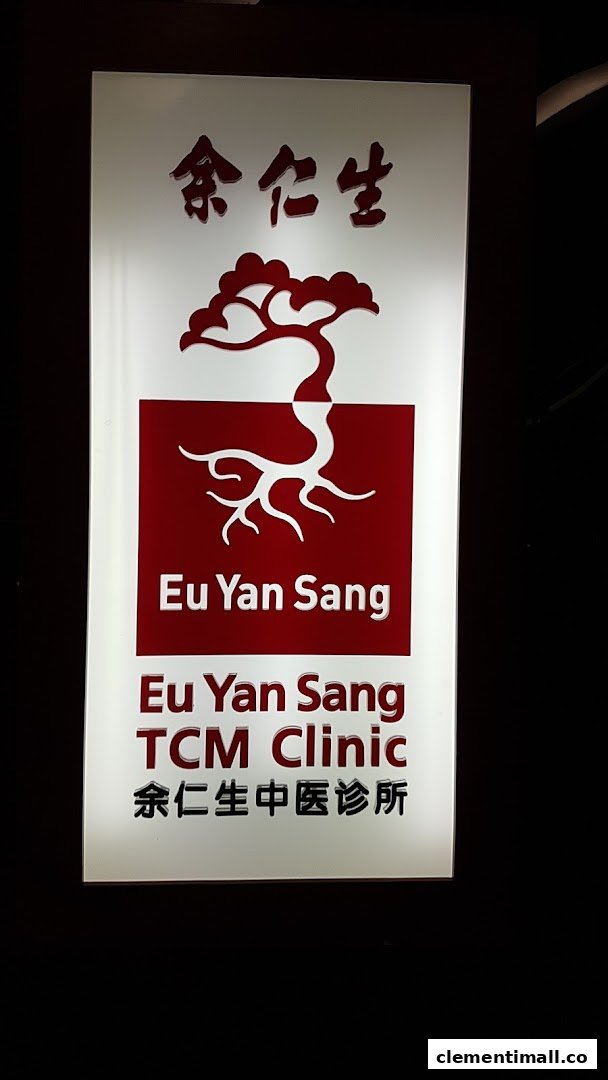 A brightly lit sign for Eu Yan Sang TCM Clinic, featuring its logo and name in English and Chinese.