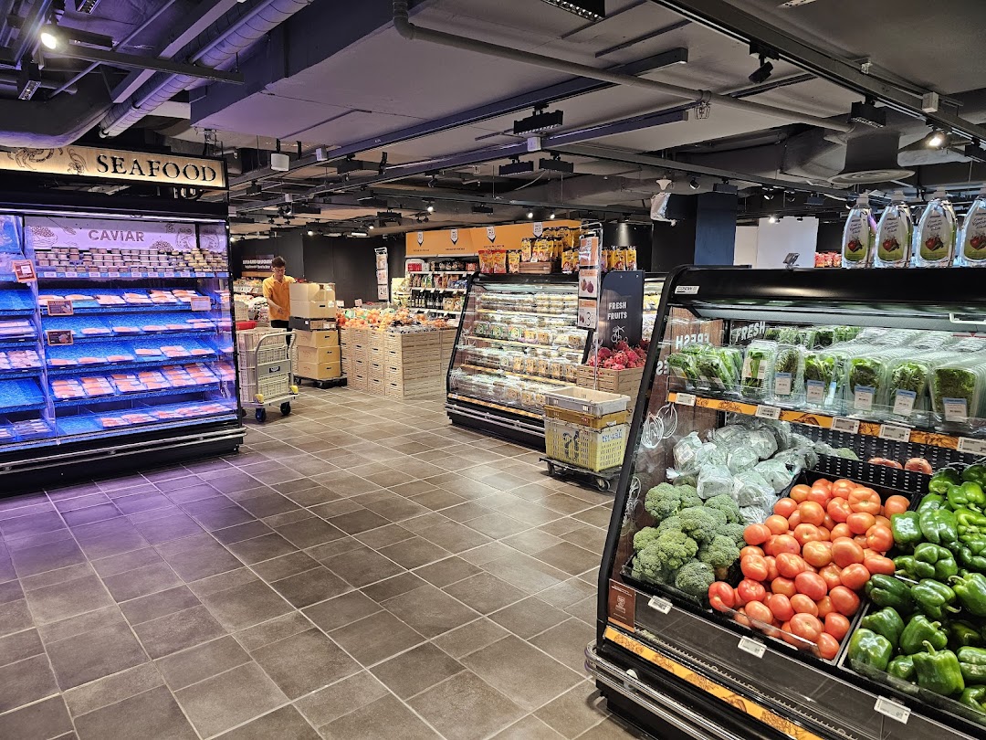Interior view of FairPrice Finest supermarket showcasing fresh produce, seafood, and a well-stocked environment.