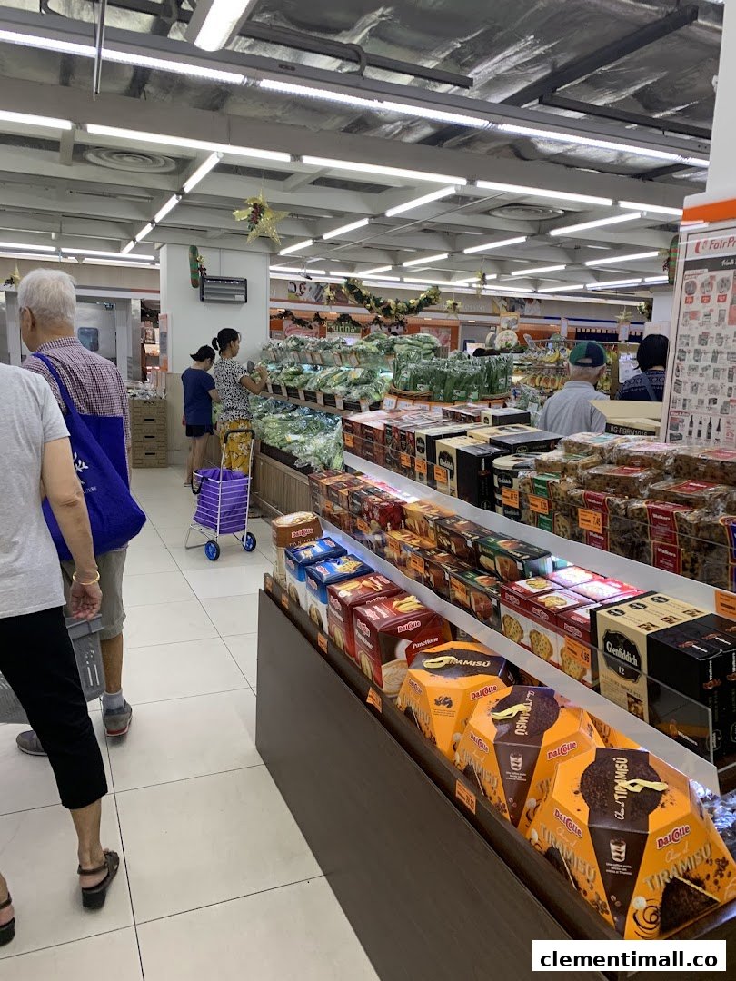 An interior view of FairPrice Finest supermarket, showing aisles with fresh produce and packaged goods, with shoppers browsing.