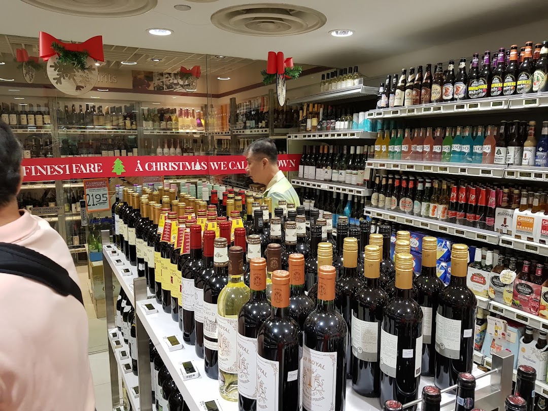 Interior view of FairPrice Finest's alcohol section, featuring a wide array of wines, spirits, and beers.