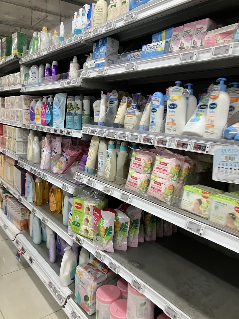A well-stocked aisle at FairPrice Finest featuring baby care products, toiletries, and health essentials.