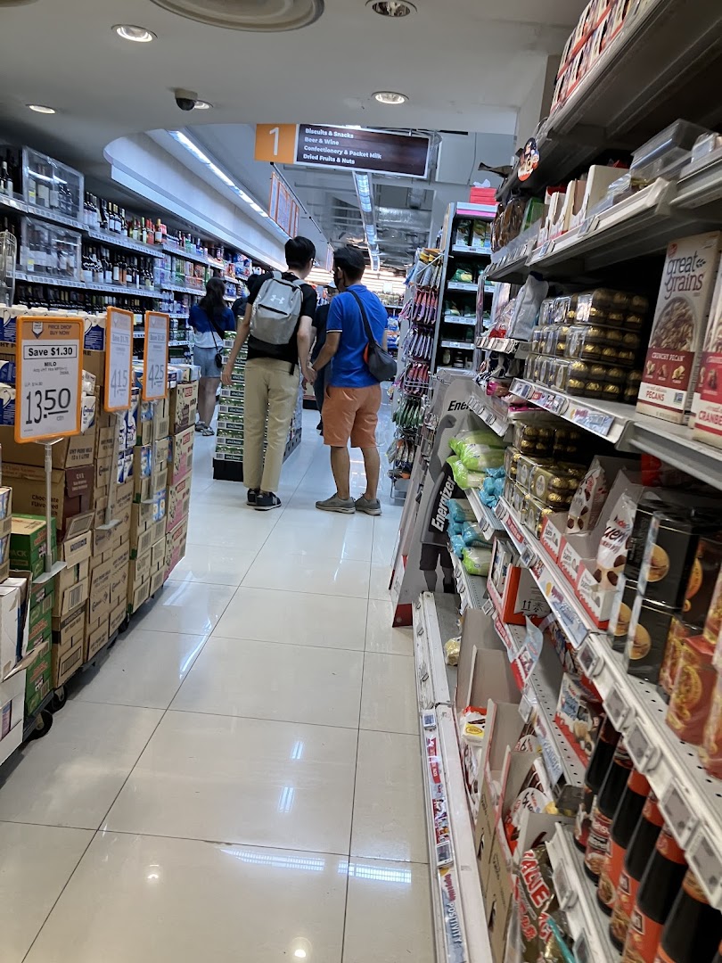 Shoppers browse well-stocked aisles at FairPrice Finest, featuring a wide array of groceries.
