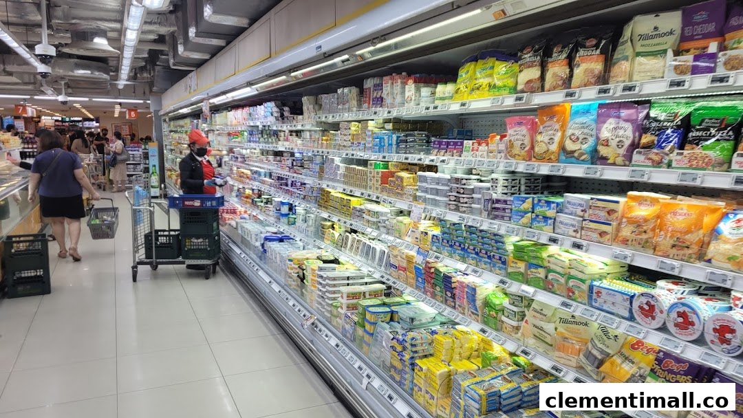 A wide aisle in FairPrice Finest supermarket, showcasing refrigerated dairy and cheese products.