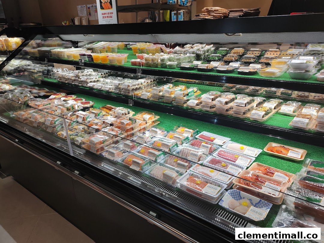 A refrigerated display case showcasing a wide variety of fresh sushi, sashimi, and pre-packaged meals.