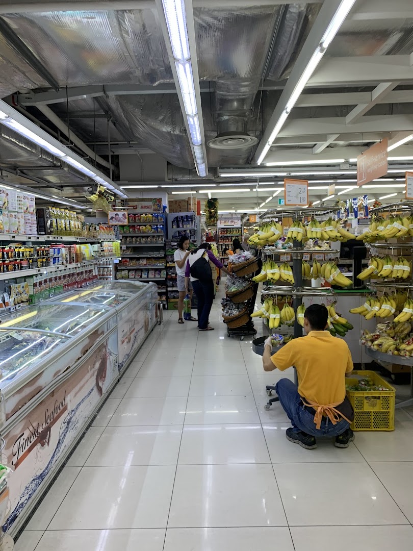 An interior view of FairPrice Finest supermarket, showcasing fresh produce, frozen goods, and shoppers.