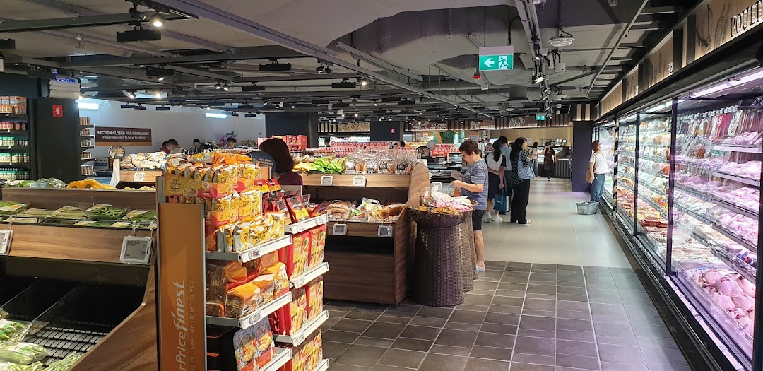 Interior view of FairPrice Finest supermarket with shoppers browsing fresh produce and refrigerated sections.