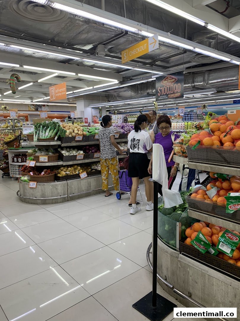 Shoppers browse fresh produce in a brightly lit FairPrice Finest supermarket aisle.