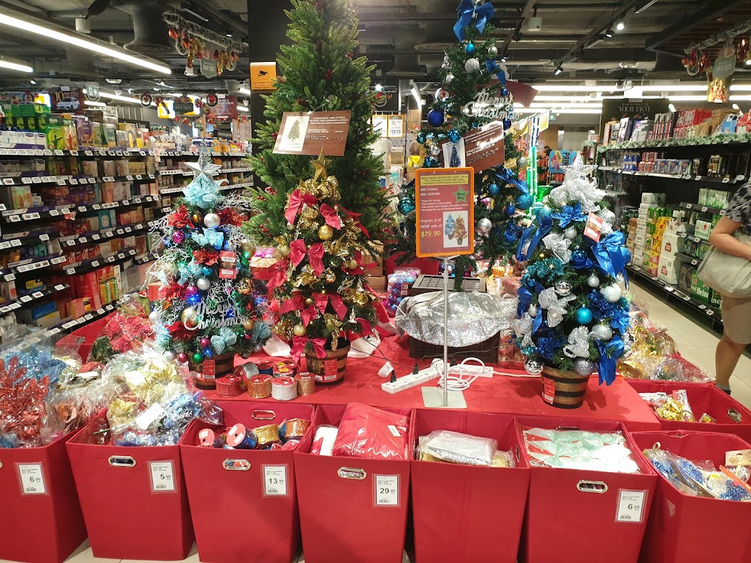 A festive display of Christmas trees and decorations inside FairPrice Finest supermarket.