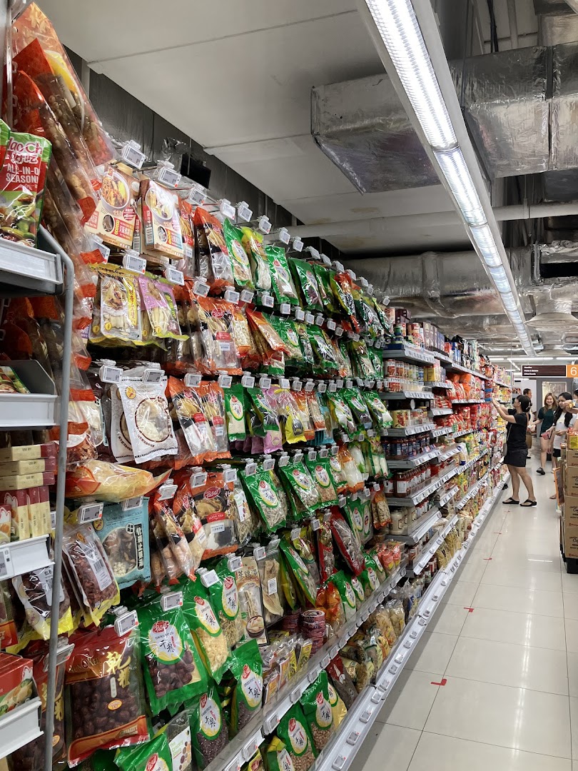 An aisle in FairPrice Finest supermarket, showcasing a wide variety of packaged food items.