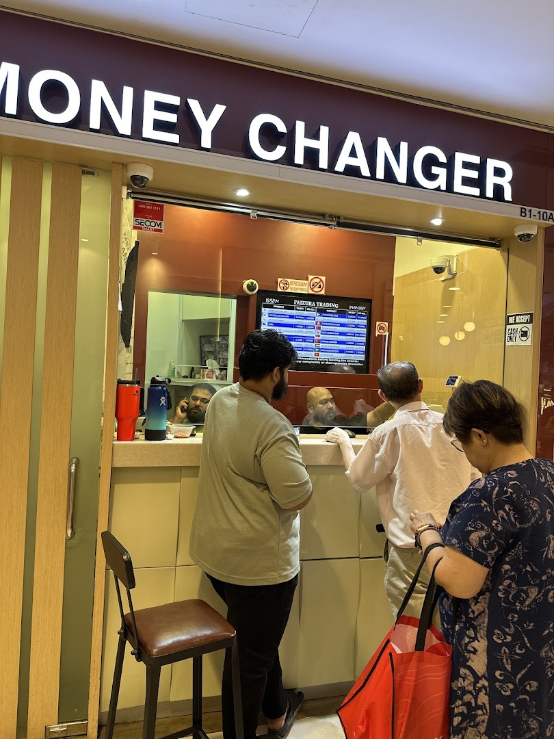 Customers transact at the counter of Faizura Trading Clementi Money Changer.