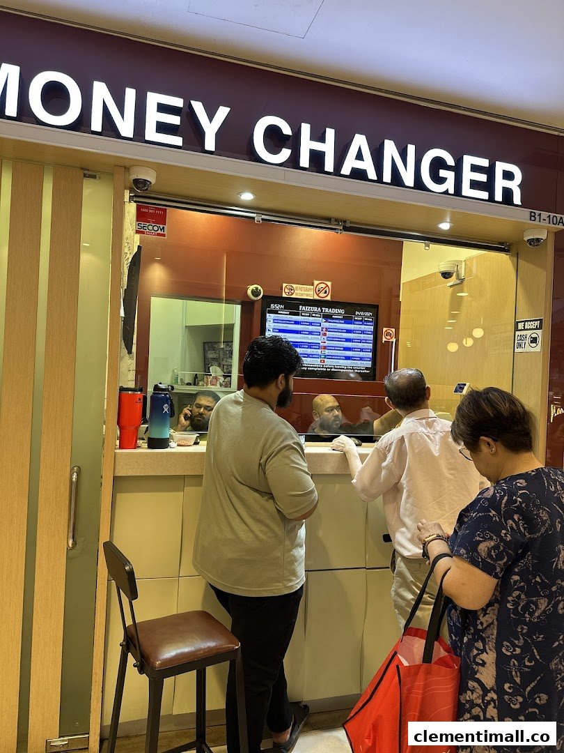 Customers transact at the counter of Faizura Trading Clementi Money Changer.