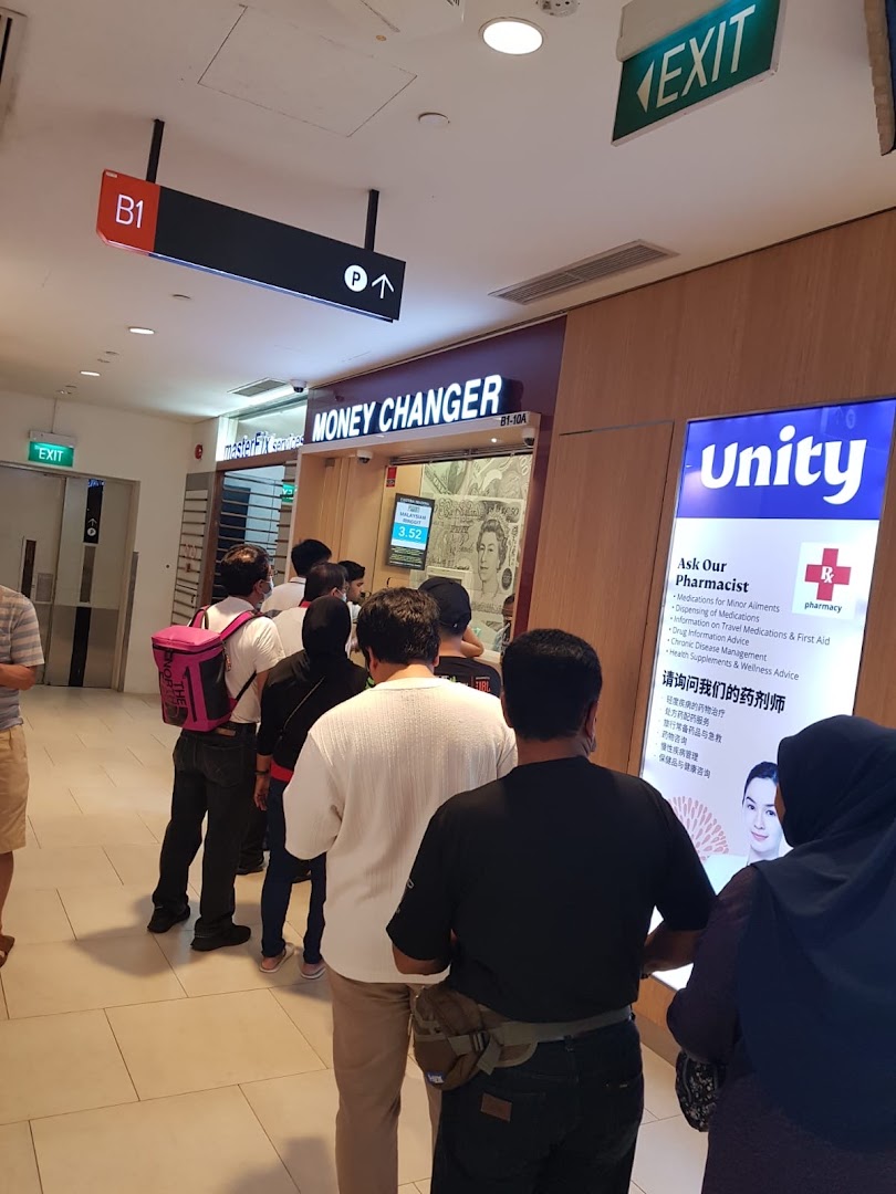 Customers queueing at Faizura Trading Clementi Money Changer counter inside a bustling shopping mall.