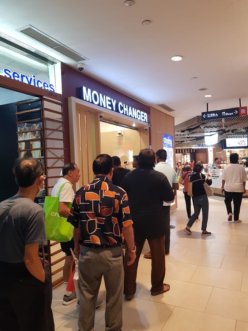 People queuing outside Faizura Trading Clementi Money Changer, an essential service in the mall.