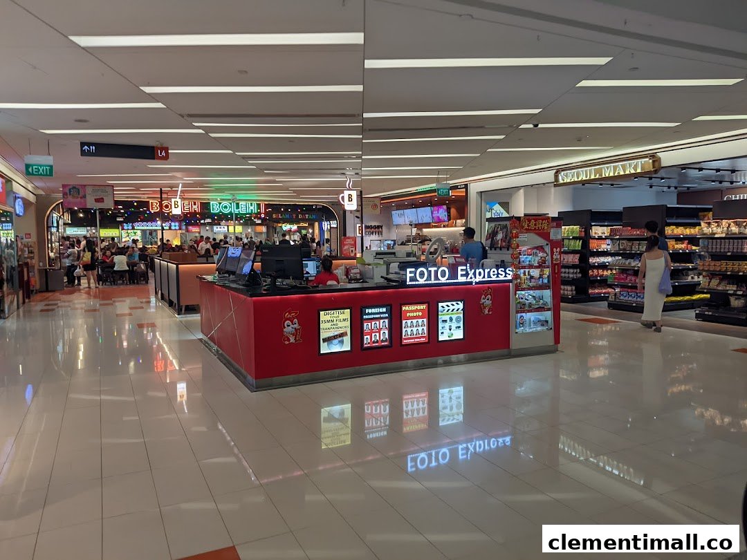 A Foto Express kiosk offering photo services, including digitizing films and passport photos, located in a bustling mall.