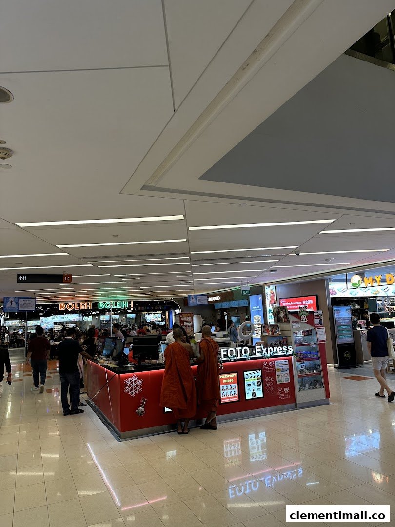 A Foto Express kiosk in a bustling mall, offering photo printing and passport services.
